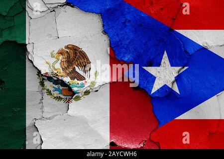 flags of Mexico and Puerto Rico painted on cracked wall Stock Photo