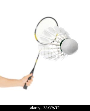 Hand with badminton racket and feather shuttlecock Stock Photo