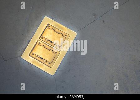 covered and protected floor 120volt outlet socket plugs Stock Photo