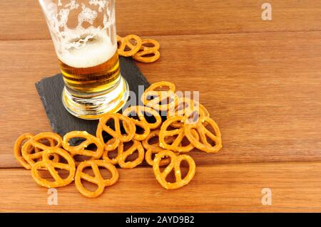 Pretzels and glass of lager on a wood background Stock Photo