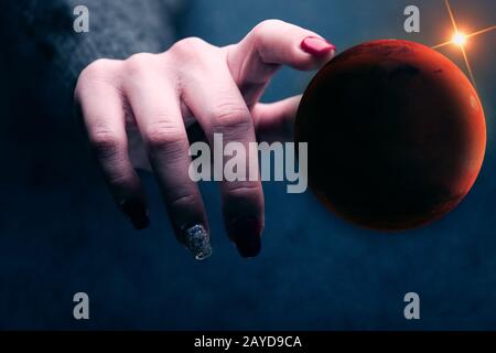 Woman touching New Home Mars. Mixed media. Stock Photo