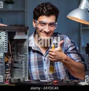 The computer repair man cleaning dust with brush Stock Photo - Alamy