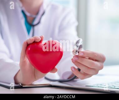 Doctor checking up heart in medical concept Stock Photo