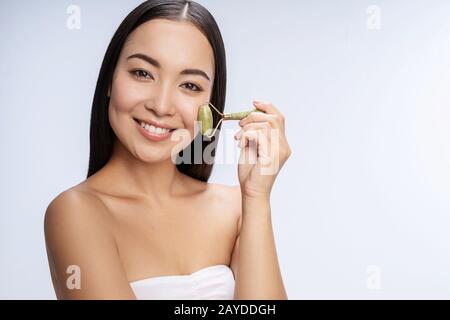 Positive delighted longhaired brunette posing on camera Stock Photo