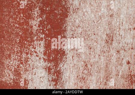 Old weathered red faded painted grunge cement wall closeup as background Stock Photo