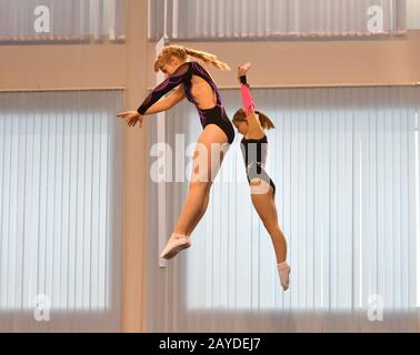 Orenburg, Russia - December 4, 2016: Girls compete in jumping on the trampoline on competitions at t Stock Photo