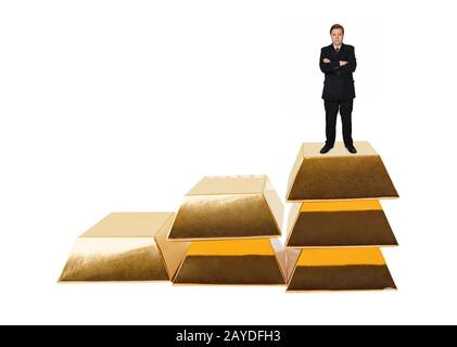 Businessman and stairs made of gold bars Stock Photo