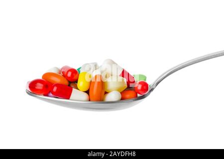Spoon with pills Stock Photo
