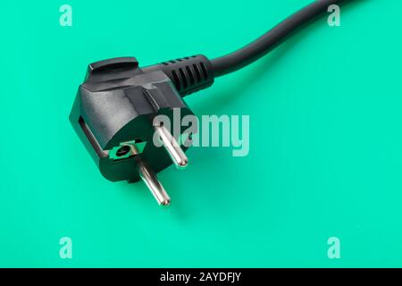 Electrical plug on green background Stock Photo