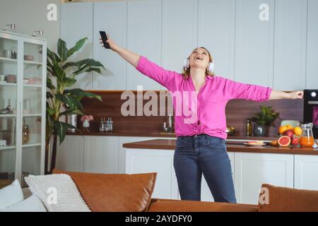 Positive delighted woman dancing in the kitchen Stock Photo