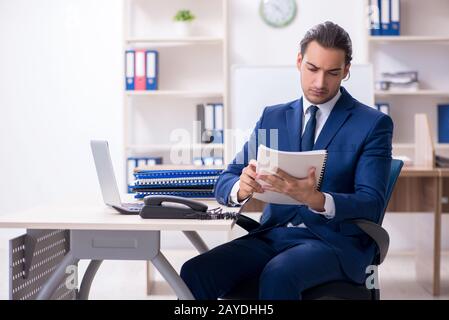 Young male businessman working in the office Stock Photo