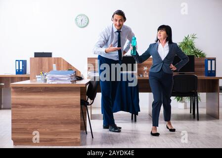 Two employees doing sport exercises in the office Stock Photo
