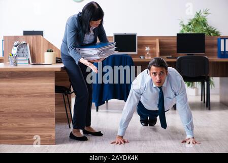Male employee doing sport exercises in the office Stock Photo
