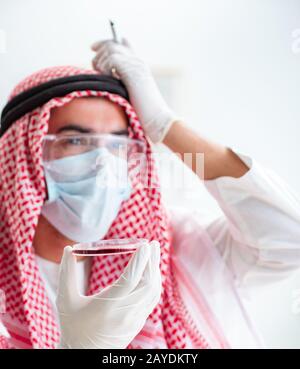 Arab doctor chemist studying new virus in lab Stock Photo
