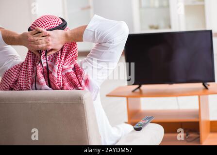 Arab businessman watching tv at home Stock Photo