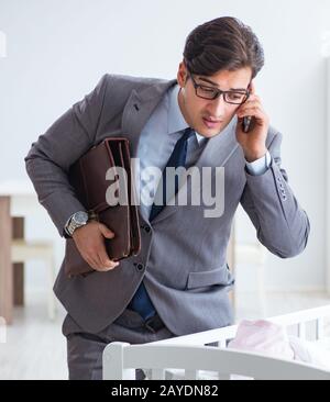 The young businessman trying to work from home caring after newb Stock Photo