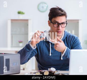 Young man mining bitcoins at home Stock Photo - Alamy