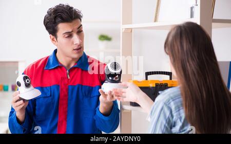 Client getting securty camera installed at home by contractor Stock Photo