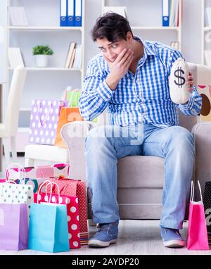 The young man after excessive shopping at home Stock Photo