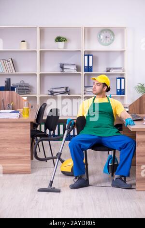 Young male contractor cleaning the office Stock Photo
