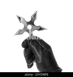 Hand is throwing ninja shuriken Stock Photo