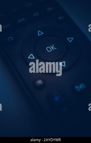 Remote control close-up. Dark blue tone. Focus on the center Stock Photo