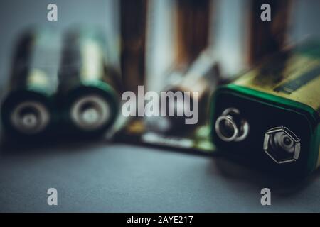 Different types of batteries on the dark table close-up Stock Photo