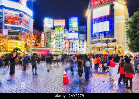 Shibuya, TOKYO, JAPAN - 29 December 2019: Famous Shibuya station and street crossing in Tokyo city with people crows walking around station square. Stock Photo