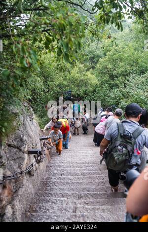 Tourists on steep mountain trail in Huashan mountain Stock Photo