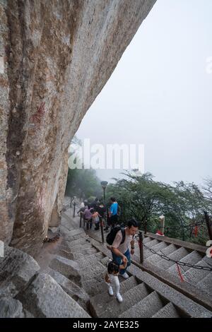 Tourists on steep mountain trail in Huashan mountain Stock Photo