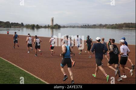 (200215) -- CANBERRA, Feb. 15, 2020 (Xinhua) -- Athletes compete during the Canberra Triathlon Festival in Canberra, Australia, Feb. 15, 2020. Due to the water quality wasn't good enough to swim in Lake Burley Griffin, the standard distance event was changed into three legs: run (5km), bike (40km) and run (10km). (Photo by Liu Changchang/Xinhua) Stock Photo