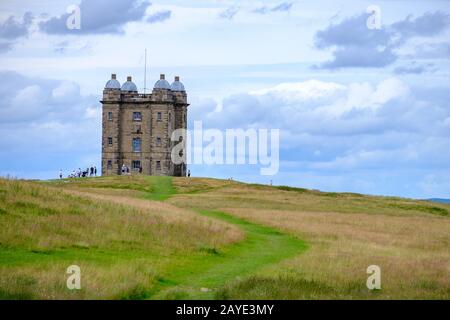 The Cage tower of the National Trust Lyme surrounded by visitors in the Peak District, Cheshire, UK Stock Photo