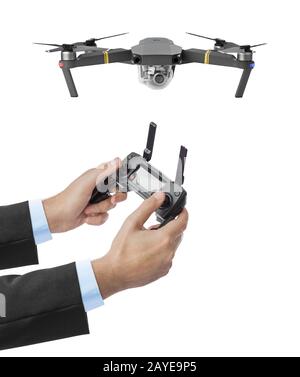 Drone and radio remote control in hands Stock Photo