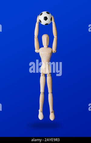 Football wooden toy figure on blue Stock Photo