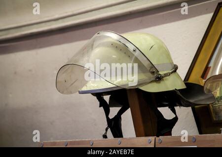 Helmets of firefighters, fire helmet are at hand parked Stock Photo
