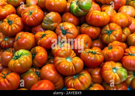 Red tomatoes background. Group of fresh tomatoes. Stock Photo