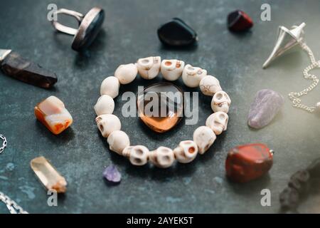 Magic flat lay. Various precious and semiprecious stones on a blue background for witchcraft. Stock Photo