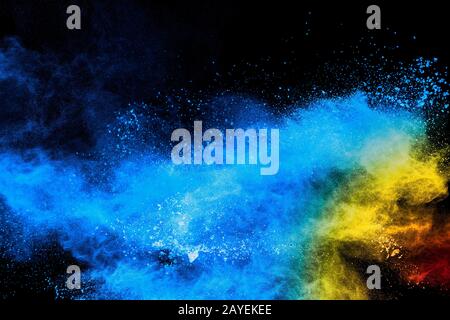 Multicolored powder explosion on black background. Stock Photo