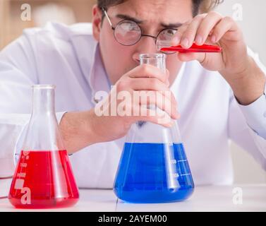 Mad crazy scientist doctor doing experiments in a laboratory Stock Photo