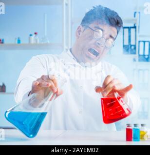 Funny mad chemist working in a laboratory Stock Photo