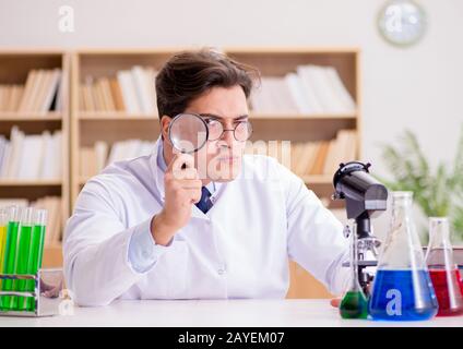Mad crazy scientist doctor doing experiments in a laboratory Stock Photo