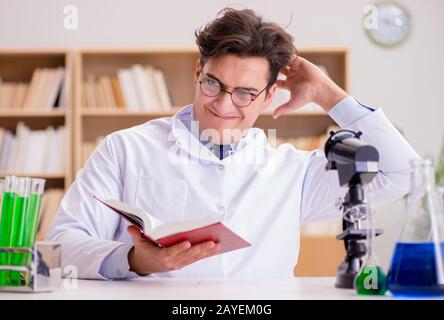 Mad crazy scientist doctor doing experiments in a laboratory Stock Photo