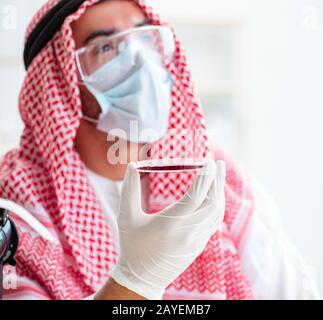 Arab doctor chemist studying new virus in lab Stock Photo