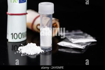 Portion of Cocaine on a dark plate as detailed close-up shot Stock Photo
