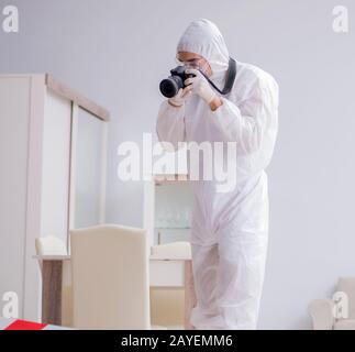 Forensic expert at crime scene doing investigation Stock Photo