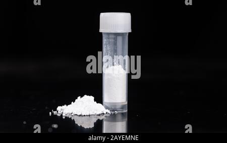Portion of Cocaine on a dark plate as detailed close-up shot Stock Photo
