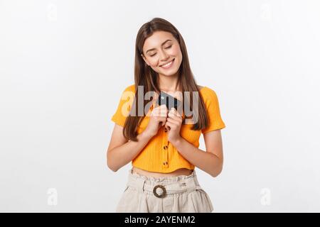 beautiful friendly smiling confident girl showing black card in hand, isolated over white background. Stock Photo