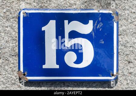 Weathered grunge square metal enameled plate of number of street address with number 15 Stock Photo