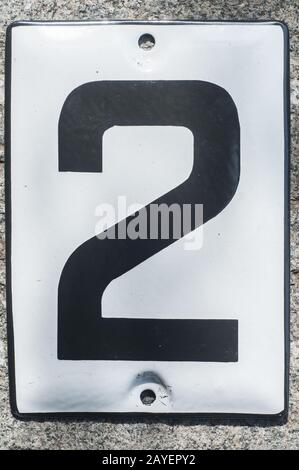 Weathered grunge square metal enameled plate of number of street address with number 2 Stock Photo