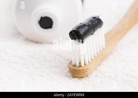 Toothbrush with black charcoal toothpaste Stock Photo